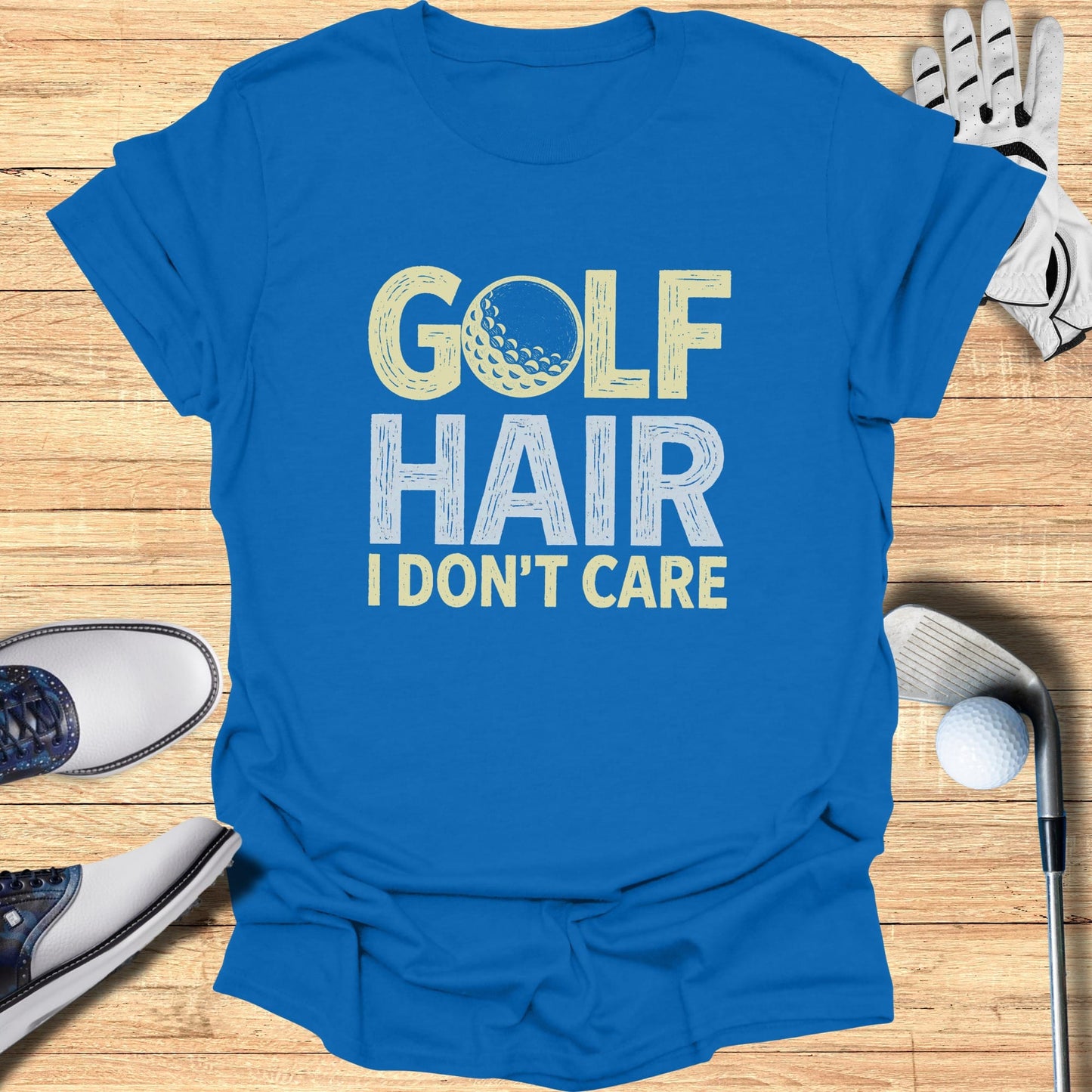 Blue t-shirt with "GOLF HAIR I DON'T CARE" text and golf ball graphic.