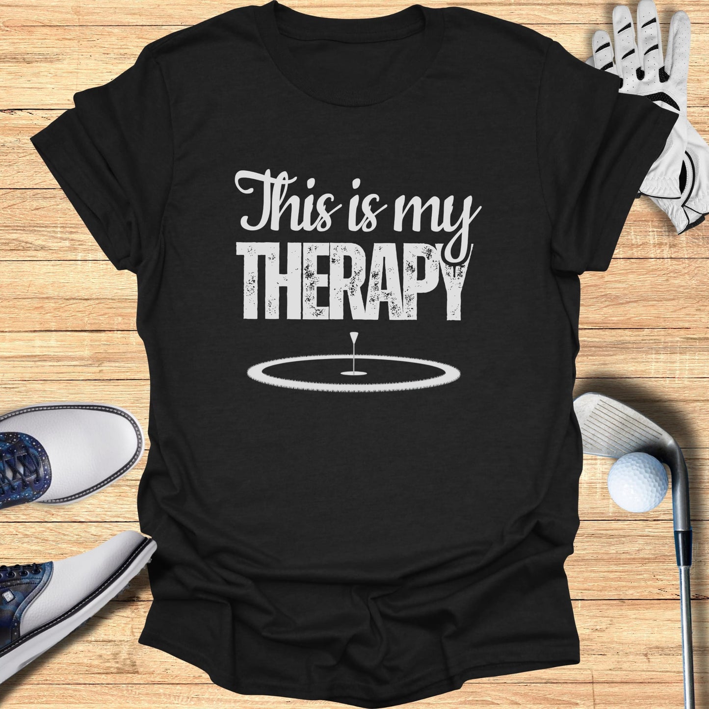 Black t-shirt with white text "This is my THERAPY" and a golf hole icon.