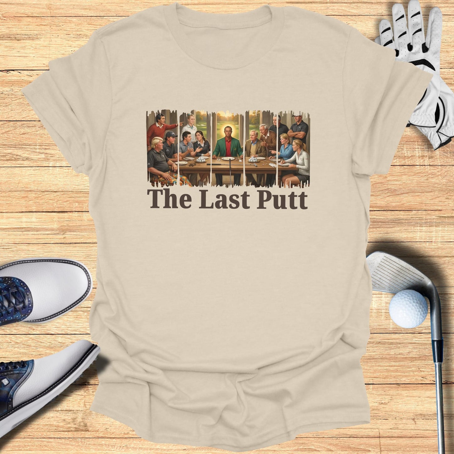 T-shirt with "The Last Putt" text and a painting of golfers around a table.