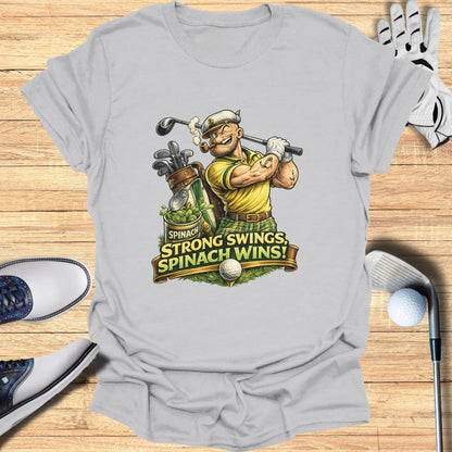 T-shirt graphic of Popeye swinging a golf club, text reads "SPINACH, STRONG SWINGS, SPINACH WINS!"