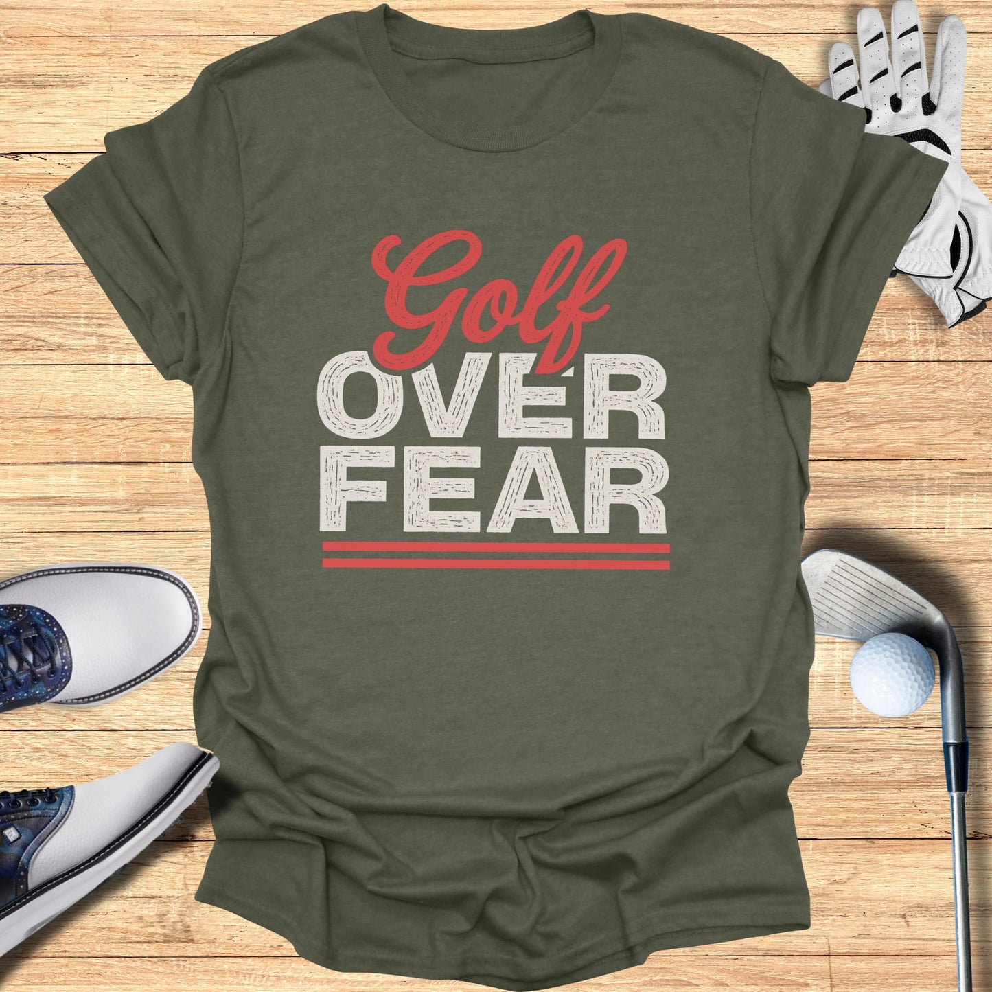 Green t-shirt with "Golf Over Fear" text and golf accessories.