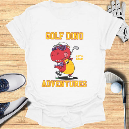 Golf Dino Adventures text on a white t-shirt with cartoon dinosaur and golf items.