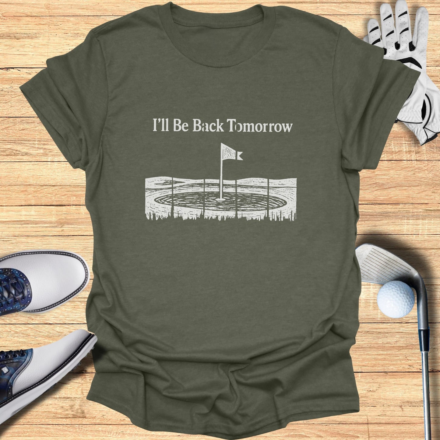 Olive t-shirt with "I'll Be Back Tomorrow" and golf flag graphic.