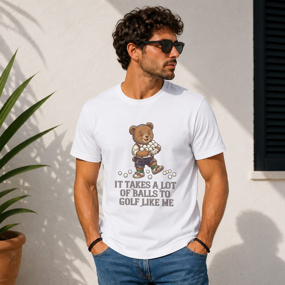 T-shirt with graphic of teddy bear holding golf balls, text reads "It takes a lot of balls to golf like me."