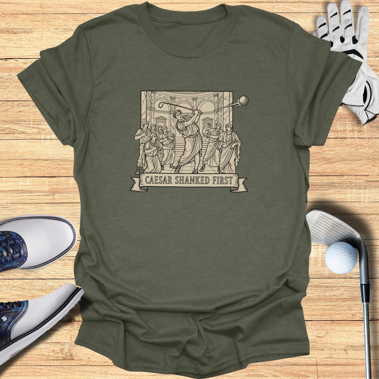 T-shirt featuring a classical scene of Caesar golfing, text "Caesar Shanked First".