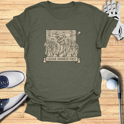 T-shirt featuring a classical scene of Caesar golfing, text "Caesar Shanked First".