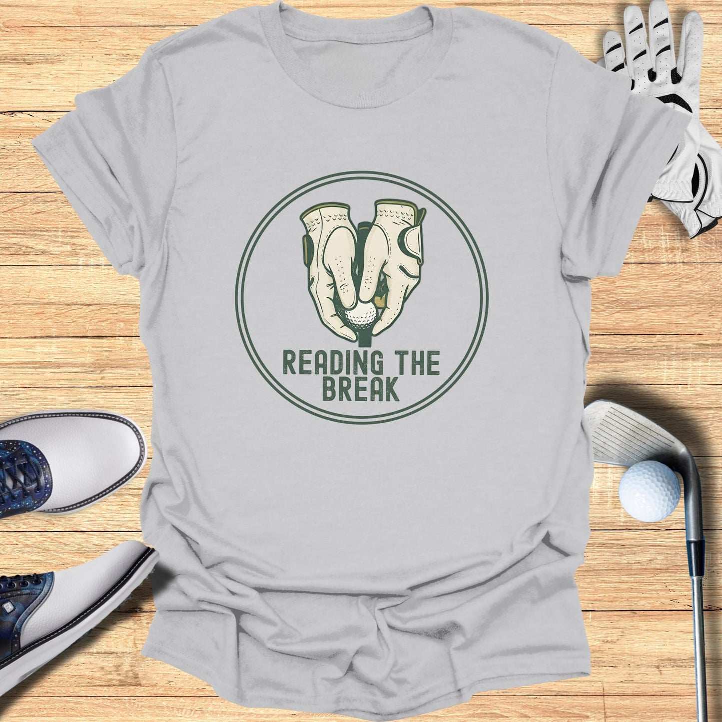 Golf gloves holding a ball above "READING THE BREAK" text.