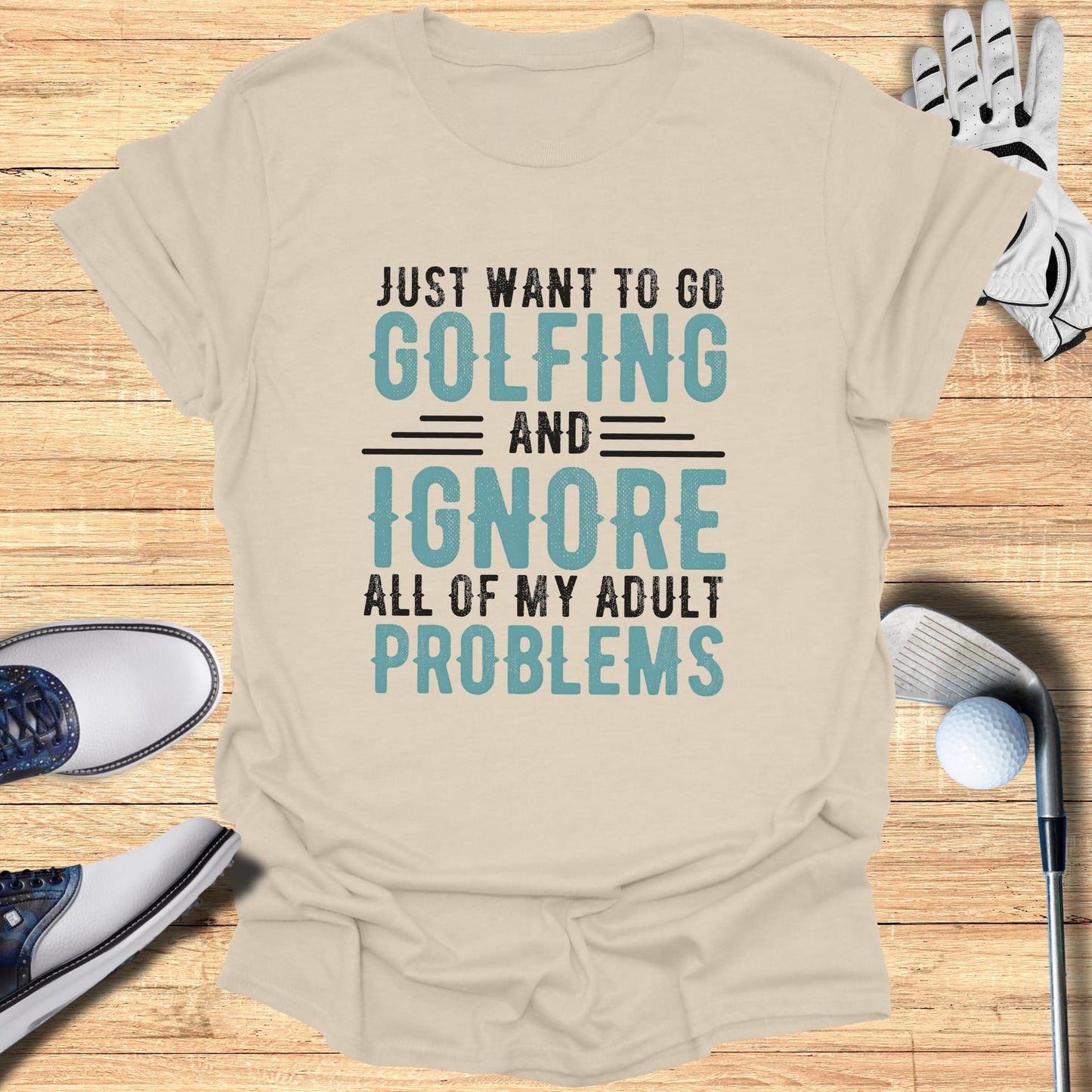 Cream t-shirt with "Just want to go golfing and ignore all of my adult problems" text.
