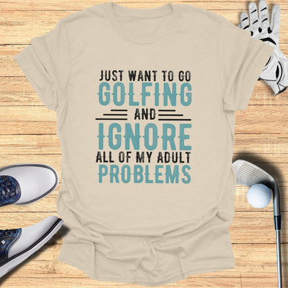 Cream t-shirt with "Just want to go golfing and ignore all of my adult problems" text.