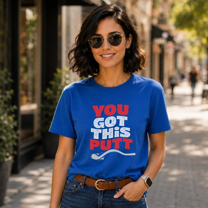 Woman wearing a blue t-shirt with "You Got This Putt" text and a spoon.