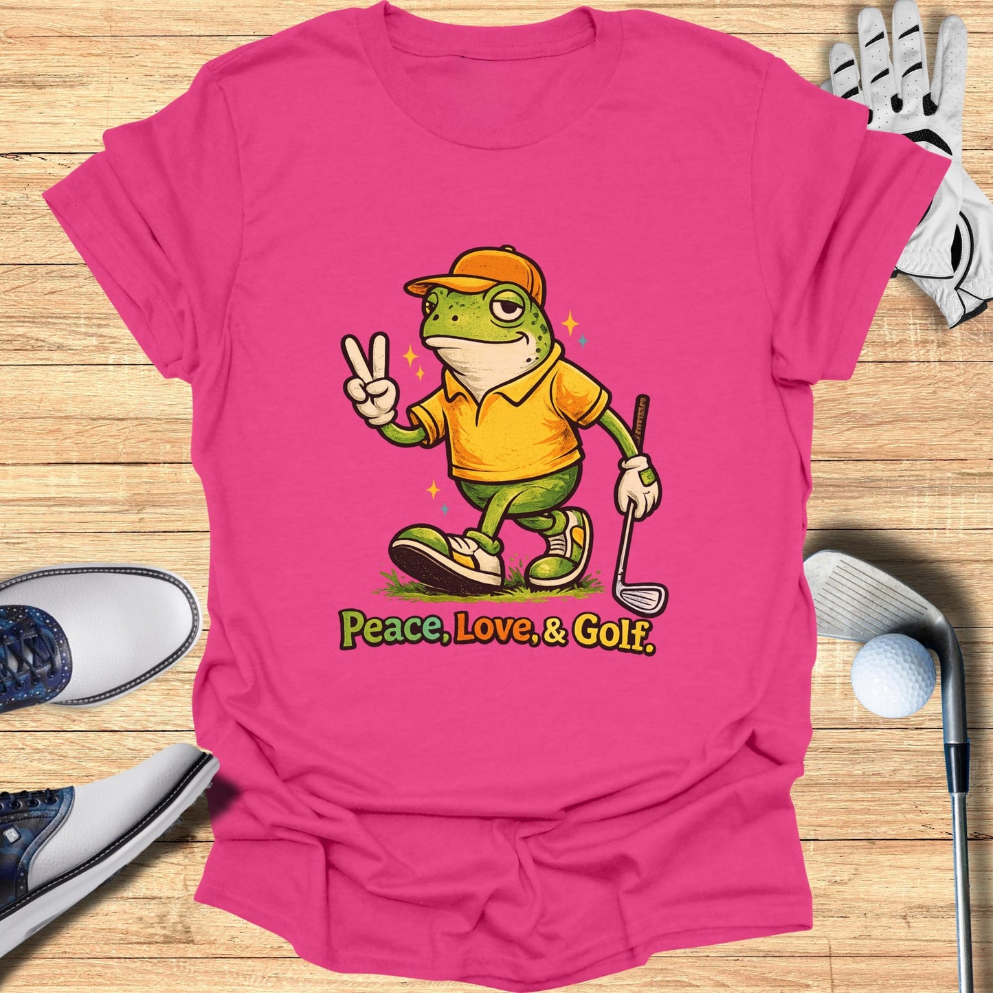 Pink t-shirt with cartoon frog giving peace sign, text reads "Peace, Love, & Golf."