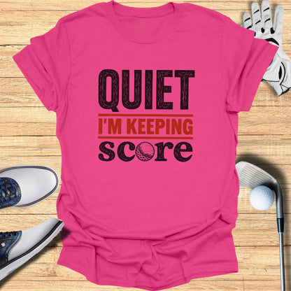 Pink t-shirt with "QUIET I'M KEEPING SCORE" and a golf ball graphic.