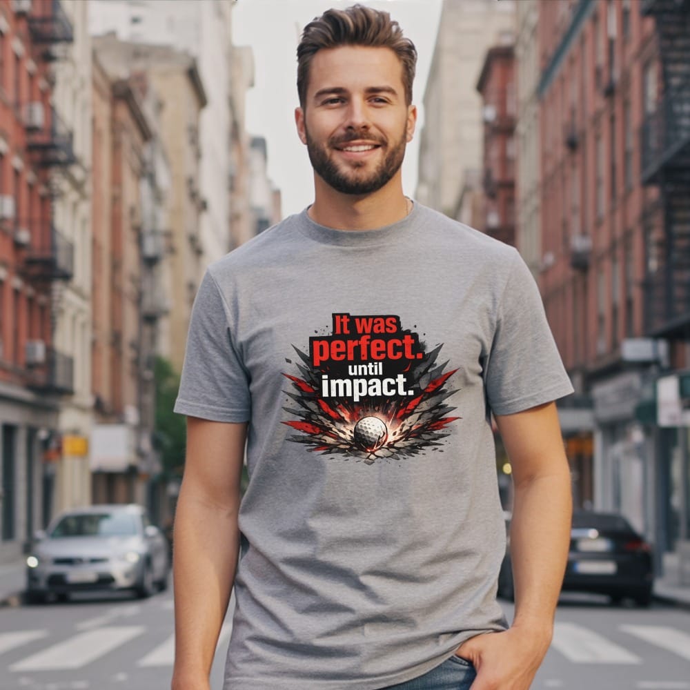 Man wearing a gray t-shirt with "It was perfect. until impact." graphic.