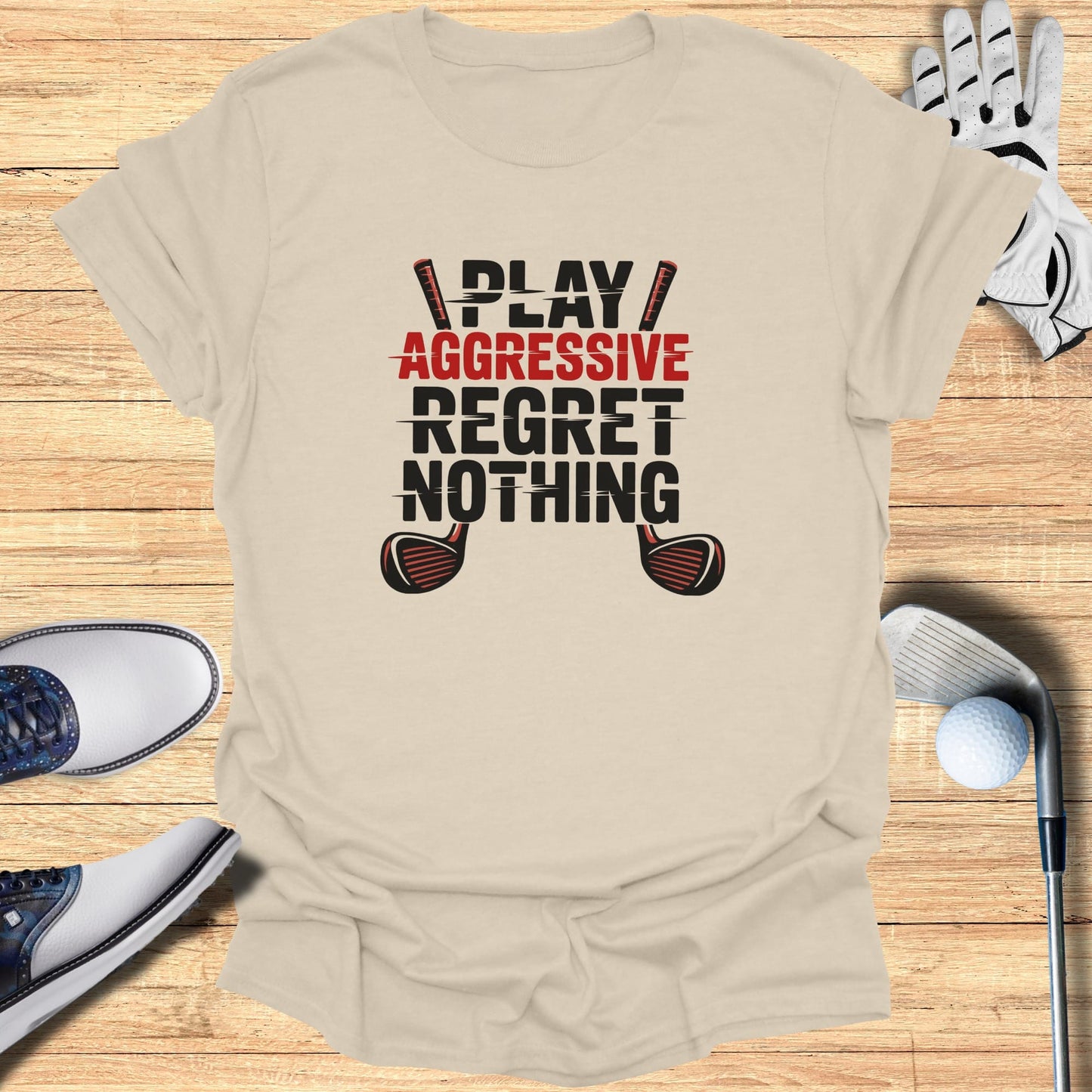 Cream t-shirt with "PLAY AGGRESSIVE REGRET NOTHING" and golf club graphics.