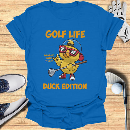 Blue t-shirt with cartoon duck wearing sunglasses and holding a golf club.
