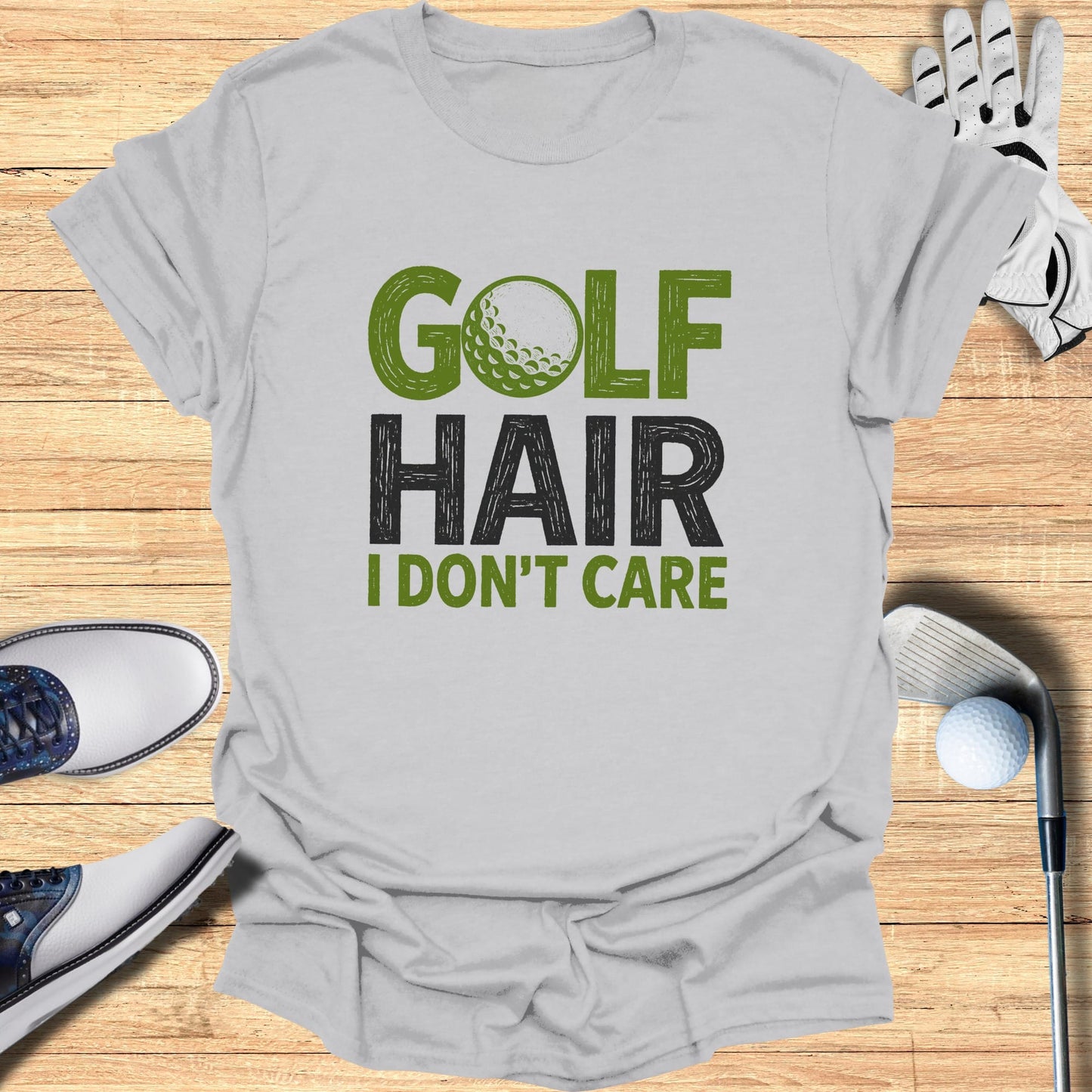 T-shirt with "GOLF HAIR I DON'T CARE" text and golf accessories.