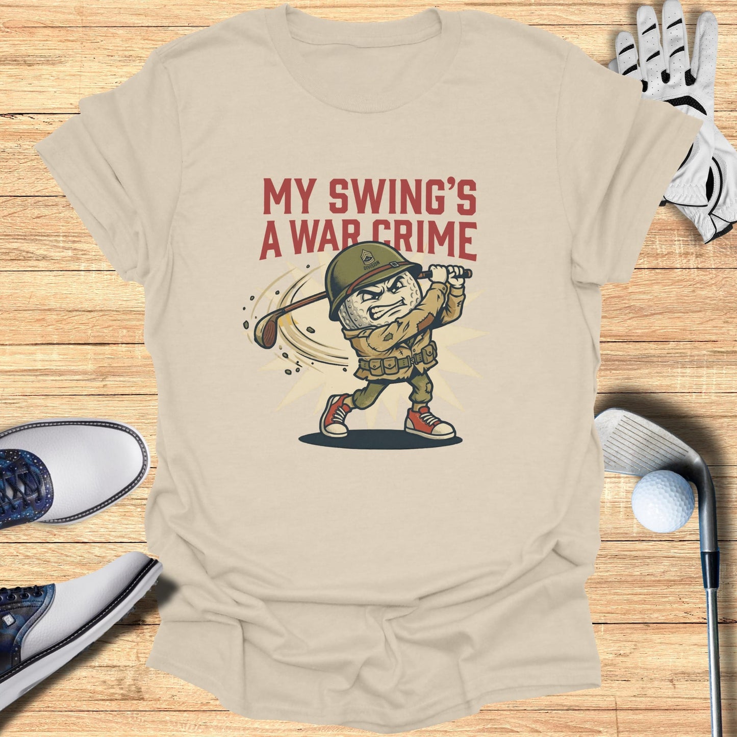 T-shirt with cartoon golfer and text "My Swing's A War Crime".