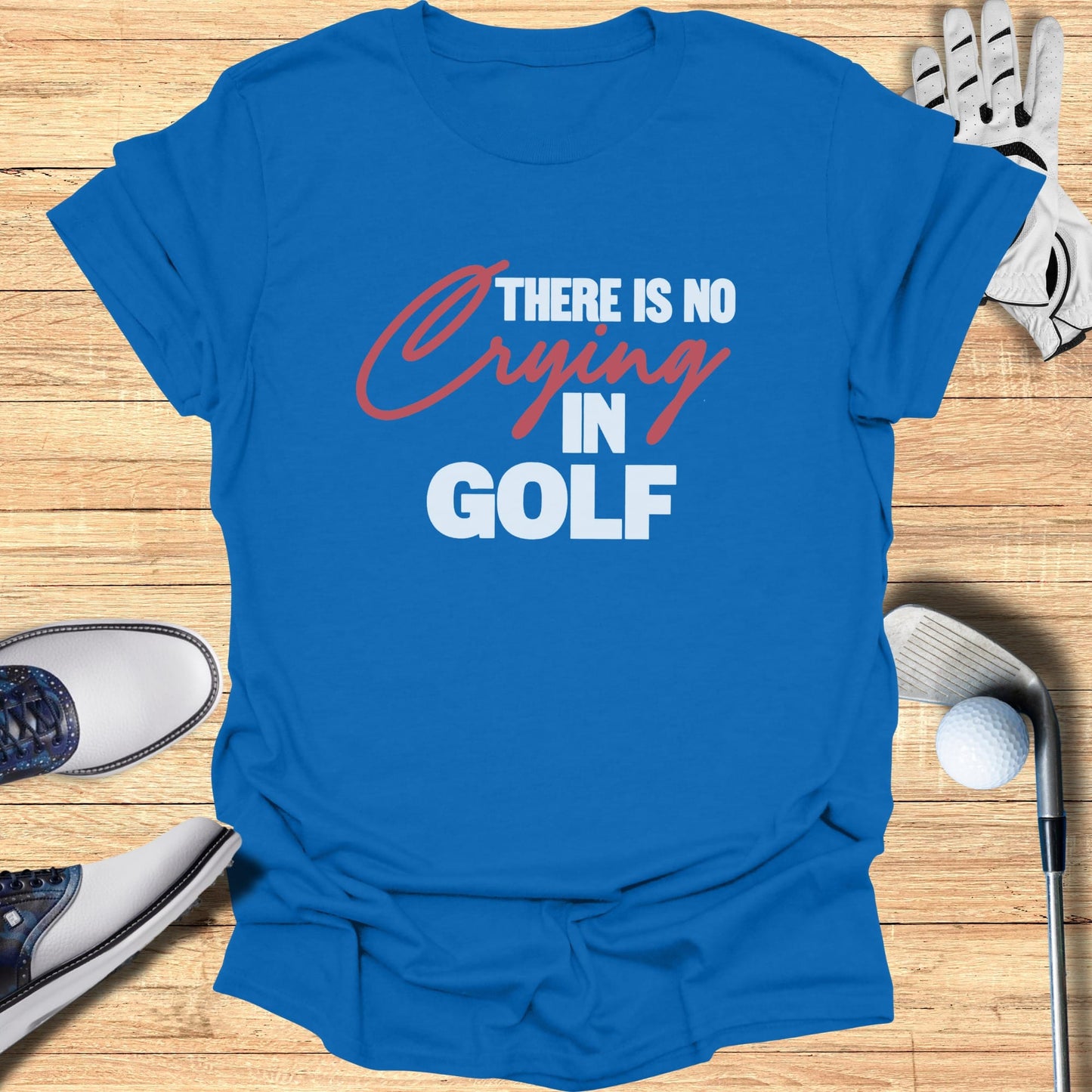 Blue t-shirt with white text that reads "THERE IS NO CRYING IN GOLF".