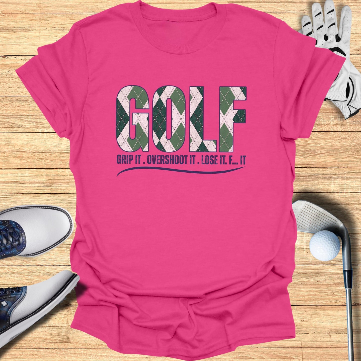 Pink t-shirt with "GOLF" in argyle pattern and text "GRIP IT. OVERSHOOT IT. LOSE IT. F... IT."