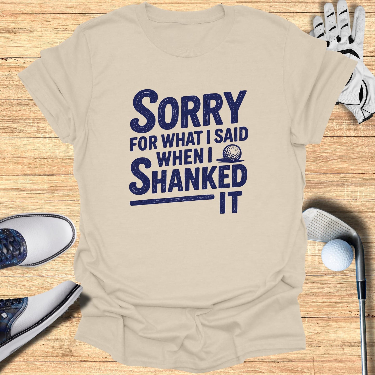 T-shirt with "Sorry for what I said when I shanked it" text and golf accessories.