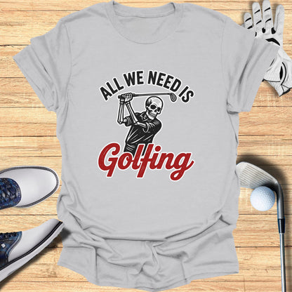 Graphic tee with skeleton golfing and text "All We Need Is Golfing".