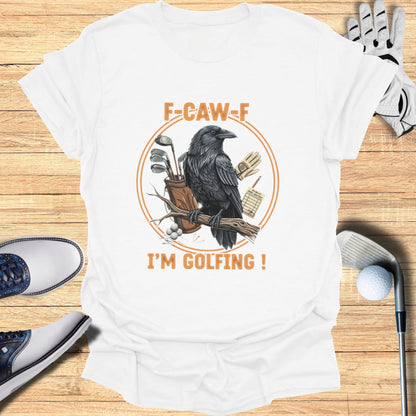 White t-shirt with a graphic of a raven on a branch, golf bag, and text "F-CAW-F I'M GOLFING!".