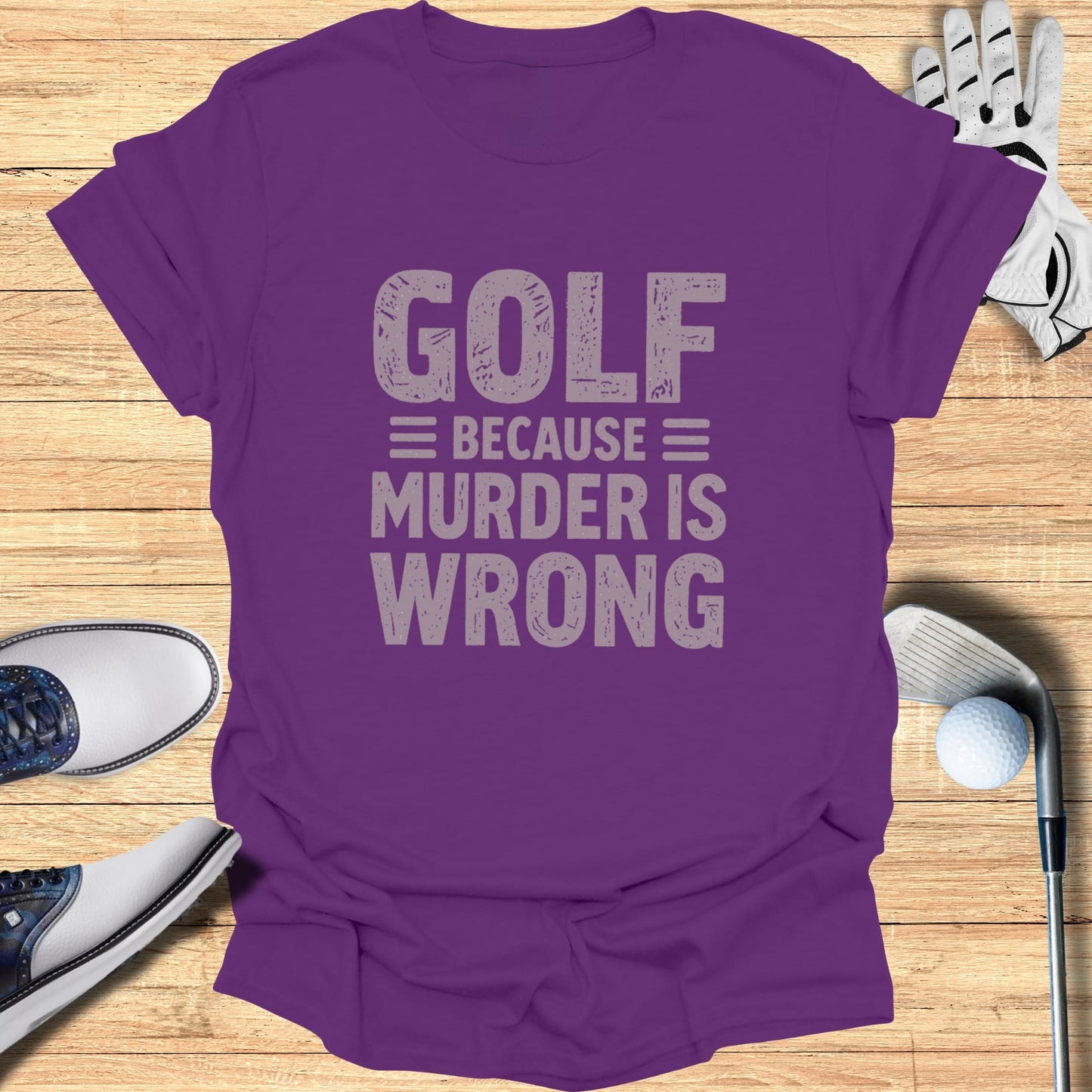 Purple t-shirt with "GOLF = MURDER IS WRONG" text, golf clubs, and shoes.