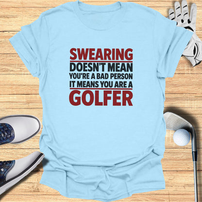 Light blue t-shirt with text: "Swearing doesn't mean you're a bad person it means you are a golfer".