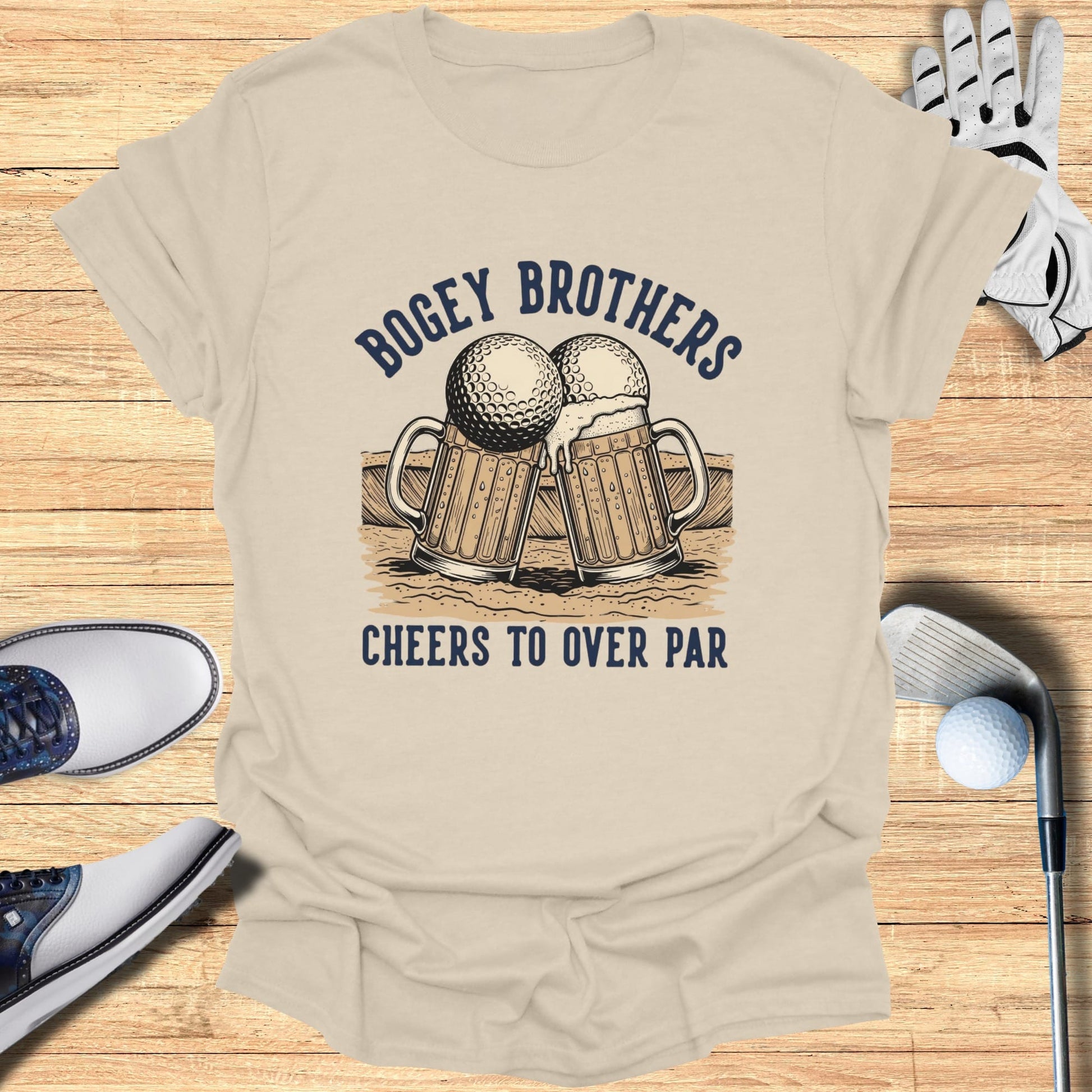 Beer mugs and golf balls graphic on tan t-shirt with text "Bogey Brothers Cheers To Over Par".