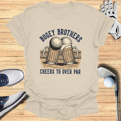 Beer mugs and golf balls graphic on tan t-shirt with text "Bogey Brothers Cheers To Over Par".