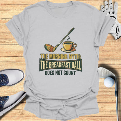 T-shirt with graphic of golf club, coffee cup, and text "The Morning Myth: The Breakfast Ball Does Not Count."