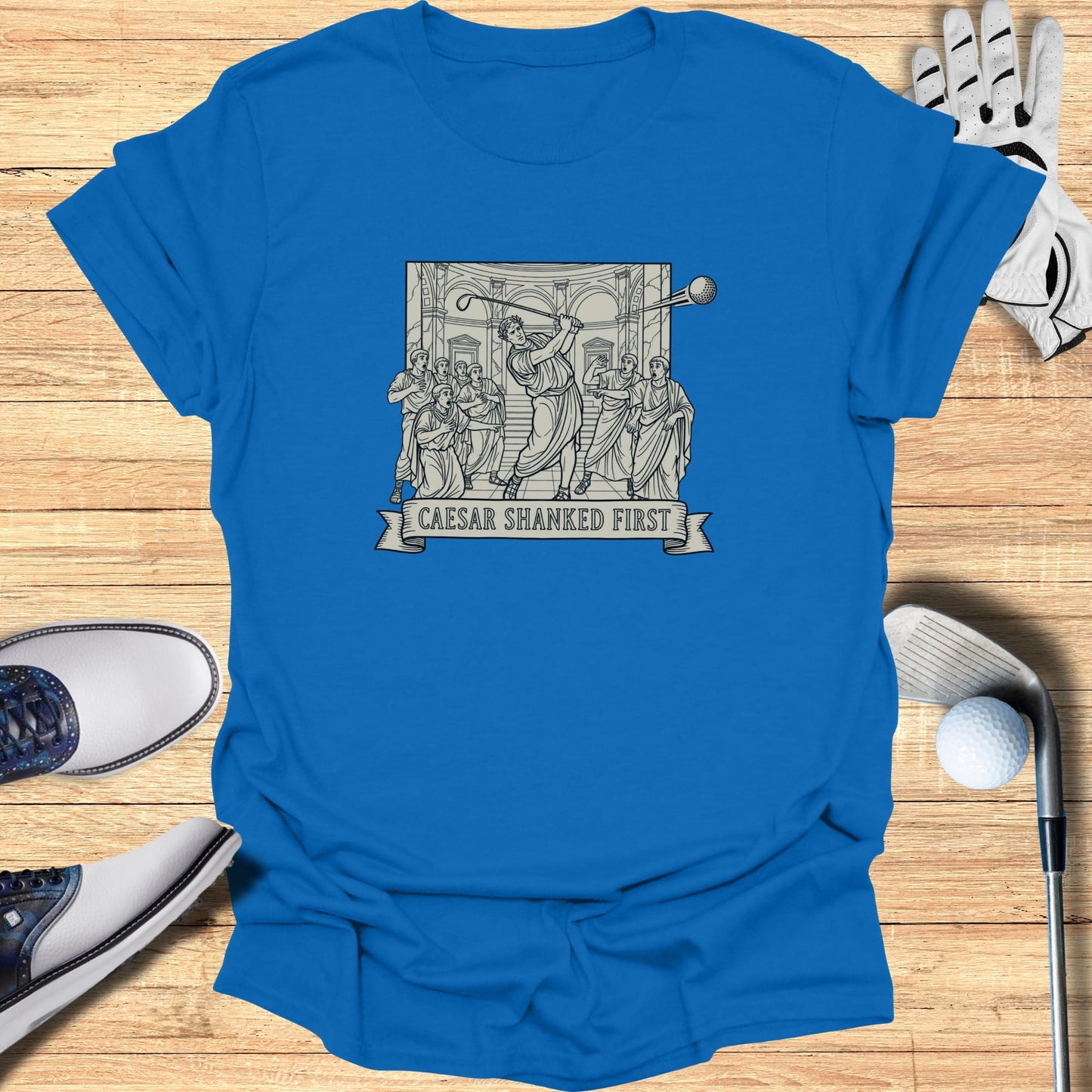 T-shirt with "Caesar Shanked First" text above a Roman-themed golf illustration.