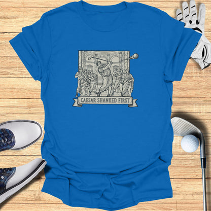 T-shirt with "Caesar Shanked First" text above a Roman-themed golf illustration.
