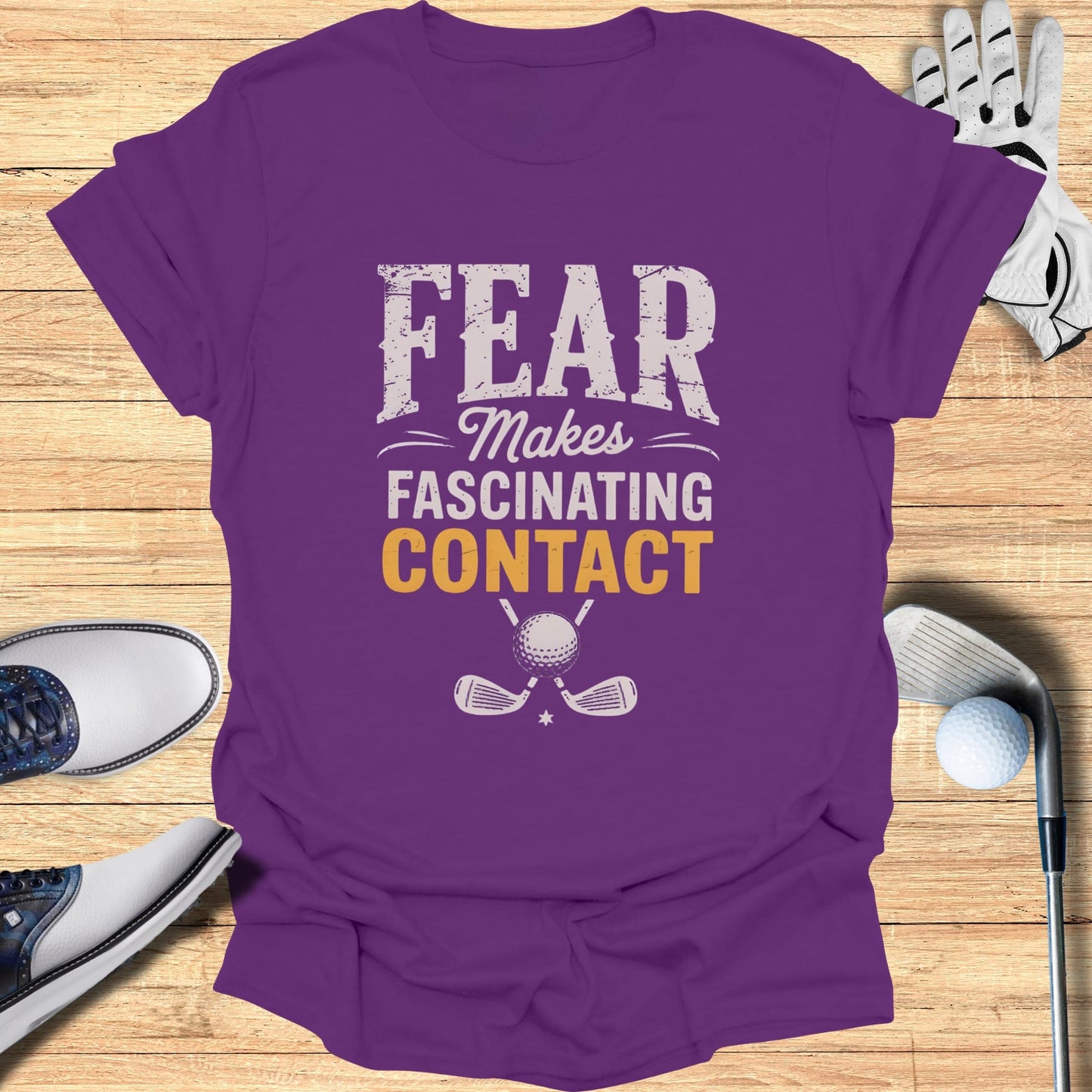 Purple t-shirt with "FEAR MAKES FASCINATING CONTACT" and golf club graphic.