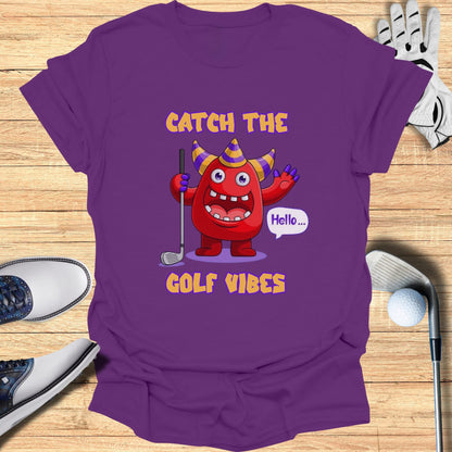 Purple t-shirt with cartoon monster and "Catch the Golf Vibes" text.