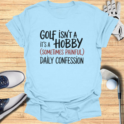 Light blue t-shirt with black text "GOLF ISN'T A HOBBY (SOMETIMES PAINFUL) DAILY CONFESSION".