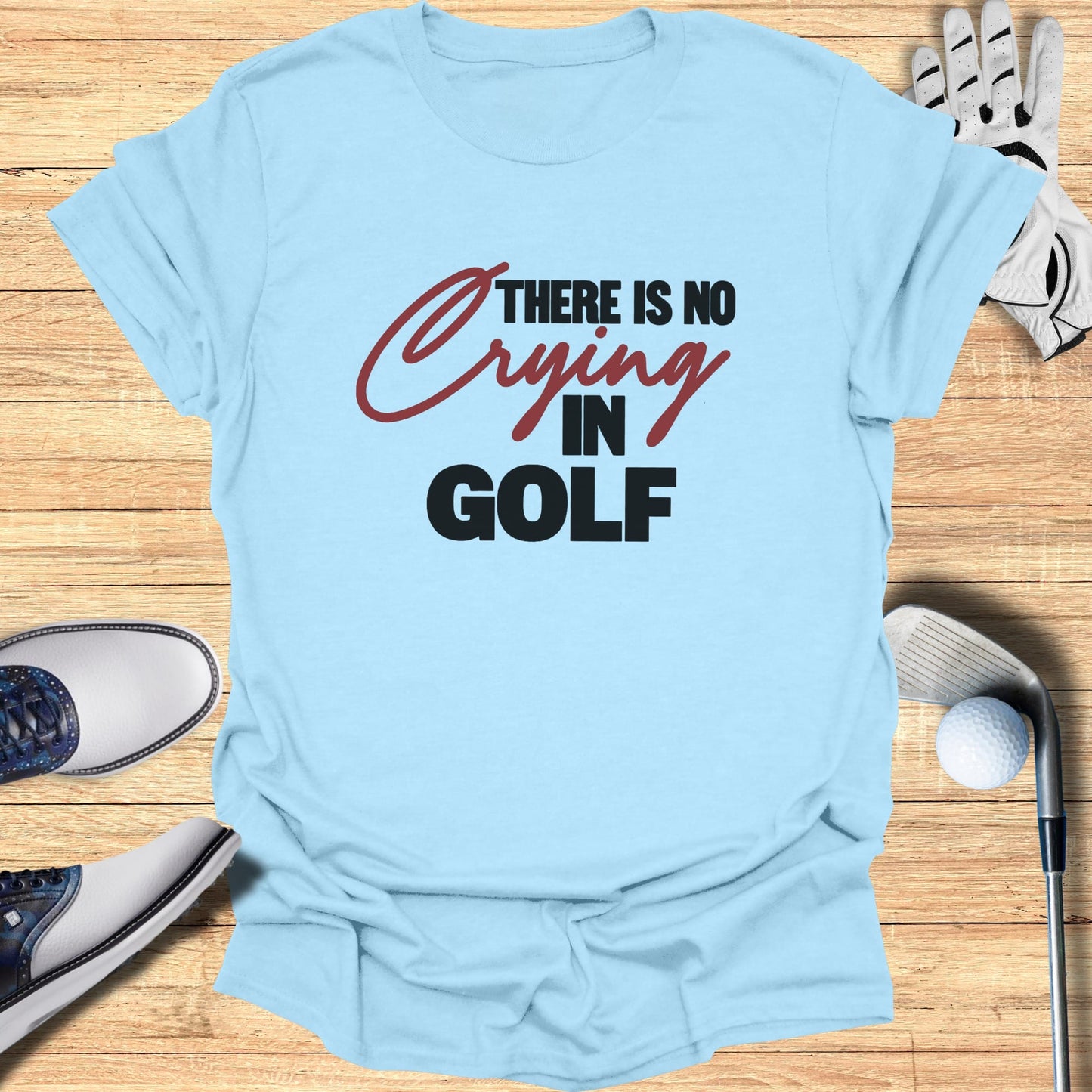 Light blue t-shirt with "THERE IS NO CRYING IN GOLF" text.