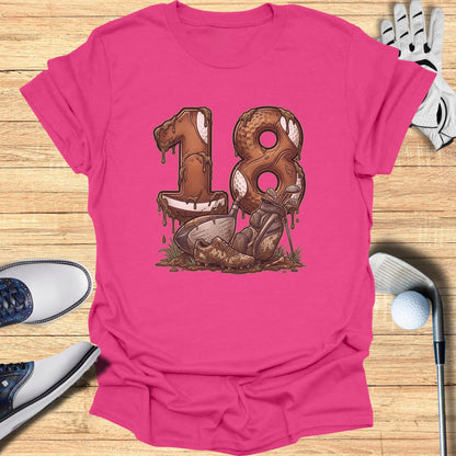 Pink t-shirt with "18" made of golf balls and muddy golf clubs.