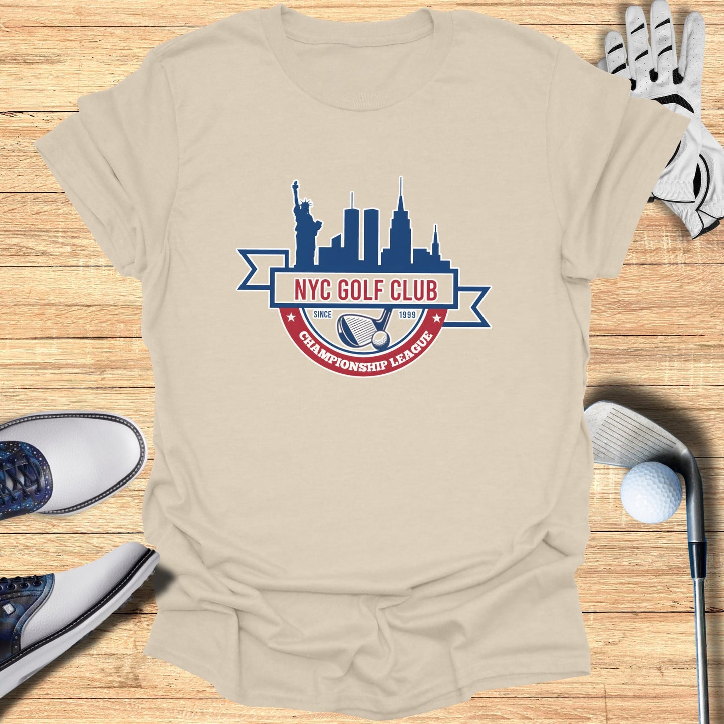 Beige t-shirt with "NYC Golf Club Championship League" logo and golf accessories.