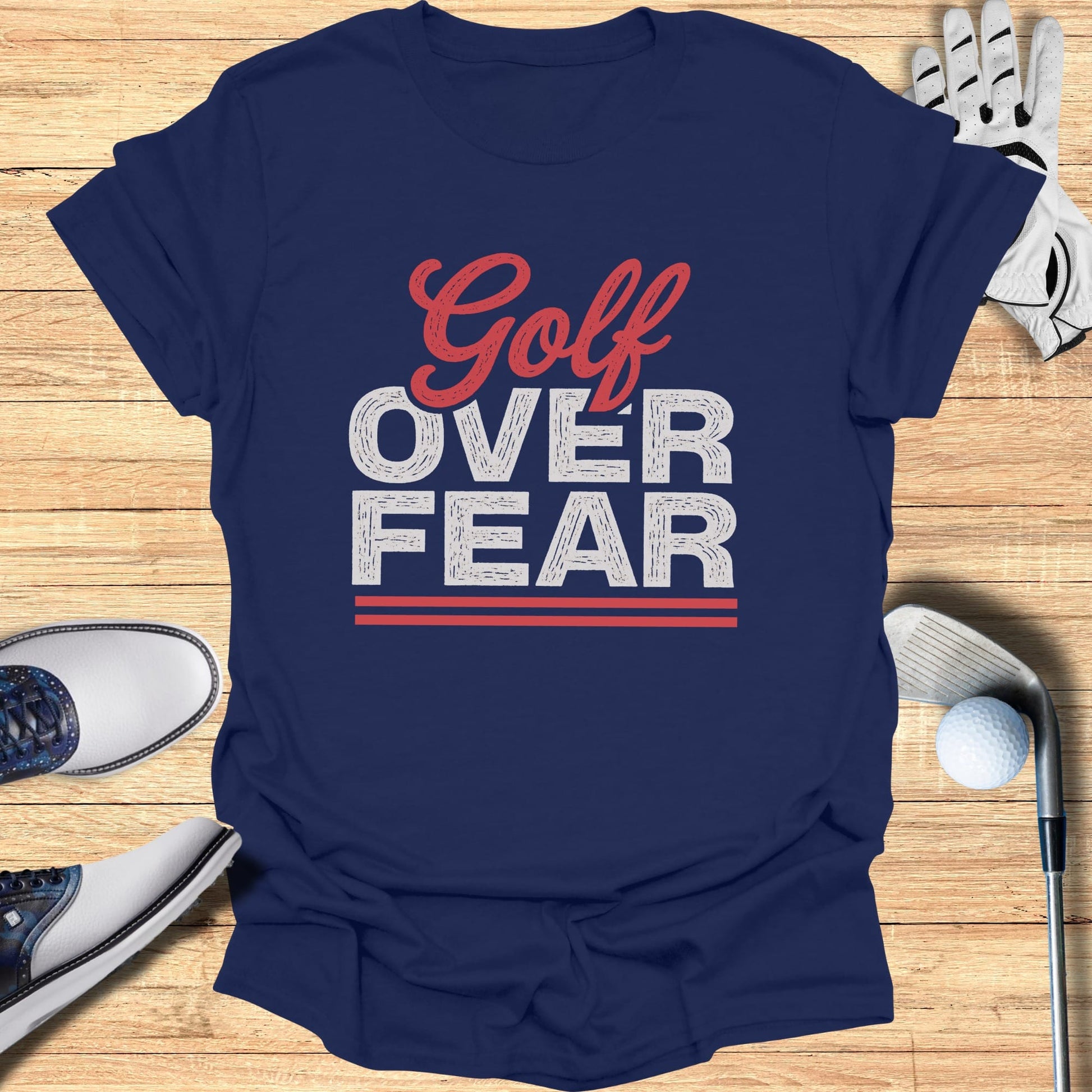 Navy t-shirt with "Golf Over Fear" graphic and golf accessories.