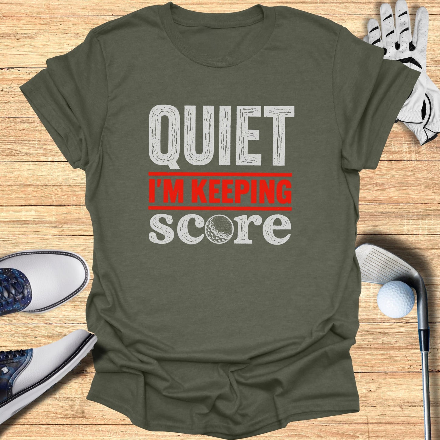 T-shirt with "QUIET I'M KEEPING SCORE" text and golf accessories.