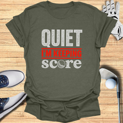 T-shirt with "QUIET I'M KEEPING SCORE" text and golf accessories.