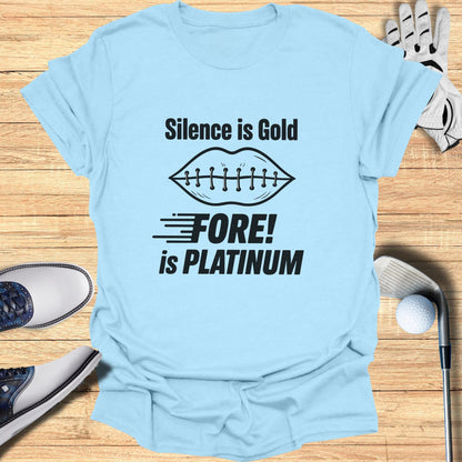 Light blue t-shirt with "Silence is Gold FORE! is PLATINUM" text and golf accessories.