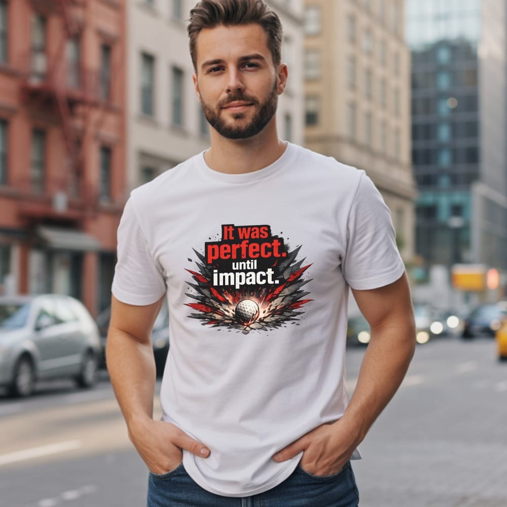 White t-shirt with red text "It was perfect. until impact." over a golf ball.