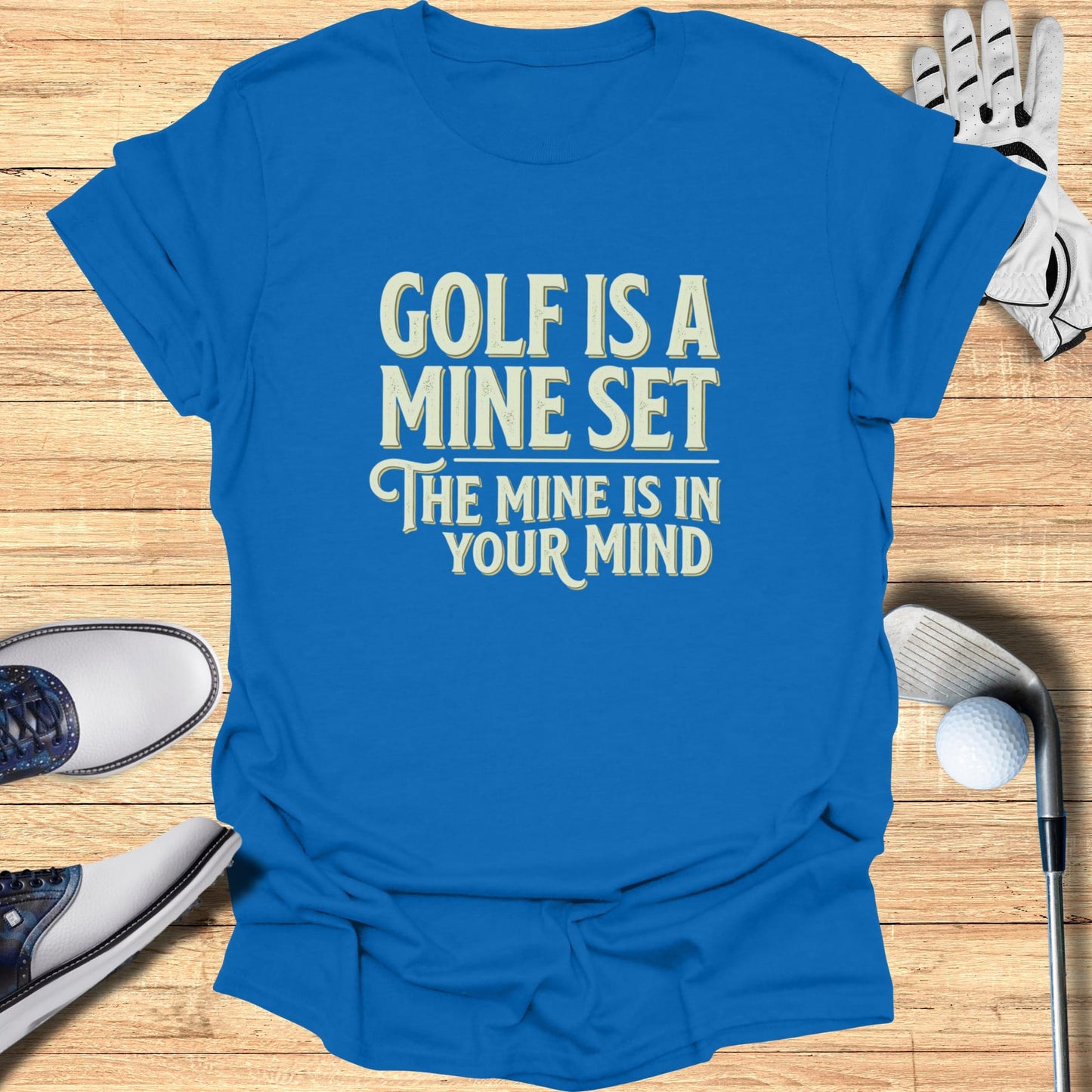 Blue t-shirt with "Golf is a mine set, the mine is in your mind" text.
