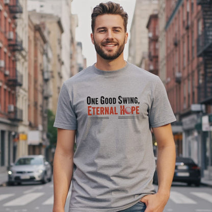 Man wearing gray t-shirt with "One Good Swing, Eternal Hope" and golf ball graphic.