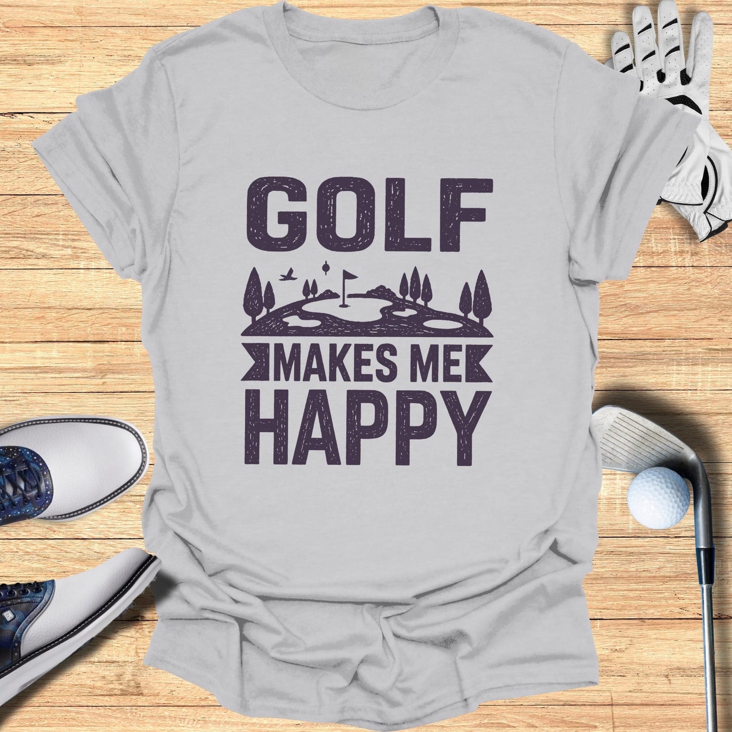 Gray t-shirt with "GOLF MAKES ME HAPPY" text and golf course illustration.