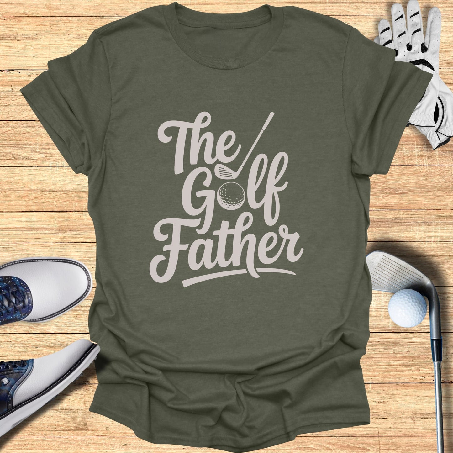 Olive green t-shirt with "The Golf Father" graphic and golf accessories.
