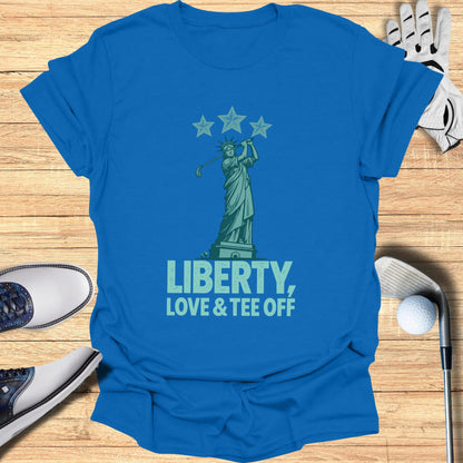 Blue t-shirt with Statue of Liberty golfing and text "LIBERTY, LOVE & TEE OFF".