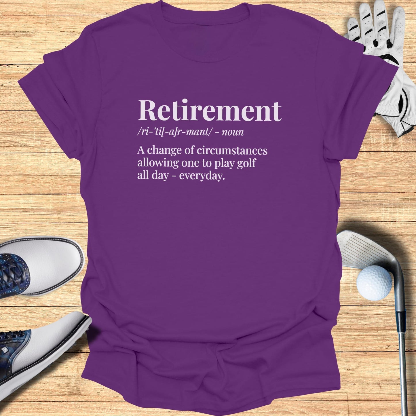 Purple t-shirt with "Retirement" definition, highlighting golf.